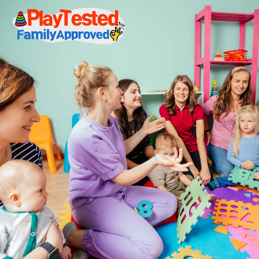 Testers playing with babies and toddlers in a playroom