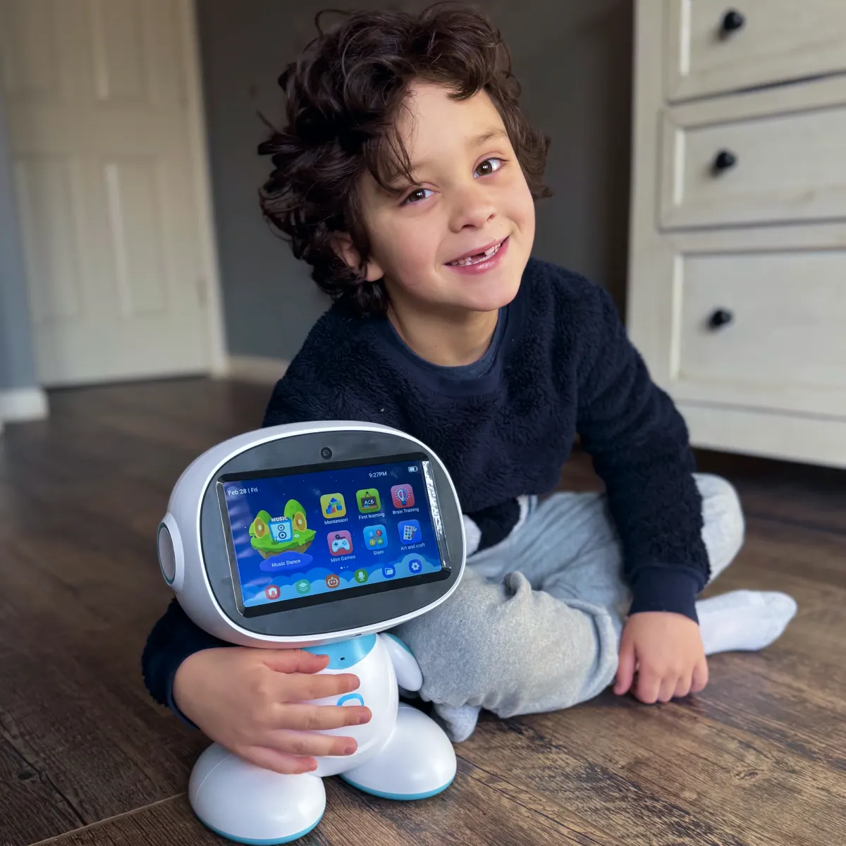 Smiling boy hugging his AI-powered learning robot at home