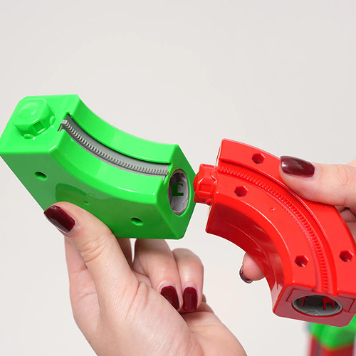 Rainbow magnetic track pieces assembled into a loop with the electric track car on it