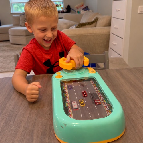 A child steering the TurboRace racing console