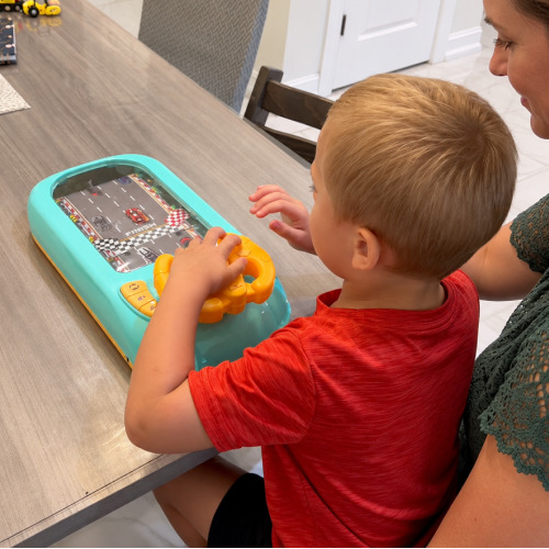 A family playing together with the TurboRace Interactive Game Set indoors