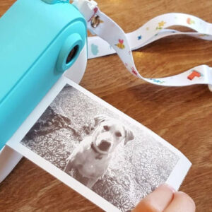 the kid instant print camera printing a photo of a dog