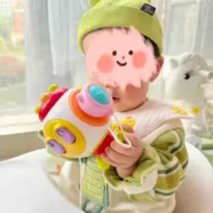 a grandson playing with the gifted hands busy ball